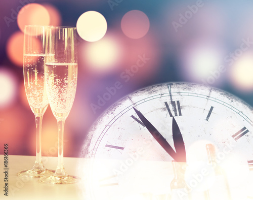 Vintage champagne glasses and midnight clock. Happy New Year 
