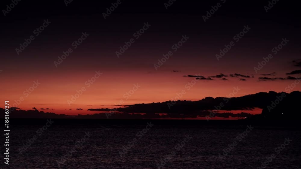 Red orange dark sky after sunset over sea water surface, Greece Peloponnese Red orange dark sky after sunset over sea water surface, Greece Peloponnese