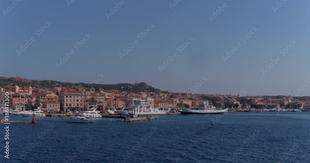 Aerial shot of Isola Maddalena harbour on a sunny day with boats and cityscape in view Aerial shot of Isola Maddalena harbour on a sunny day with boats and cityscape in view