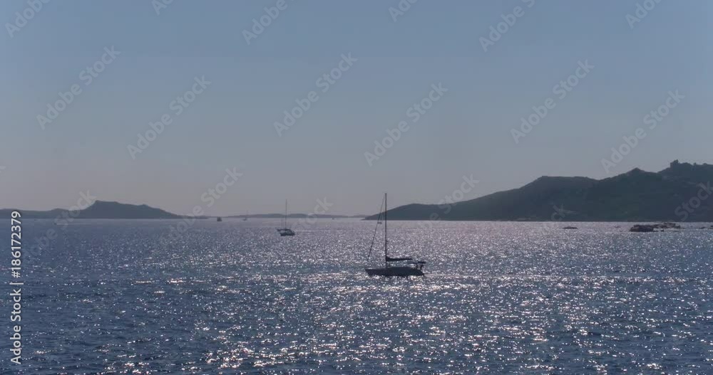 Video shot of boats on a beautiful day near Isola Maddalena with landscape and sea in view Video shot of boats on a beautiful day near Isola Maddalena with landscape and sea in view