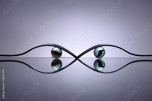 Photos Spoons and marbles on table with mirros reflections