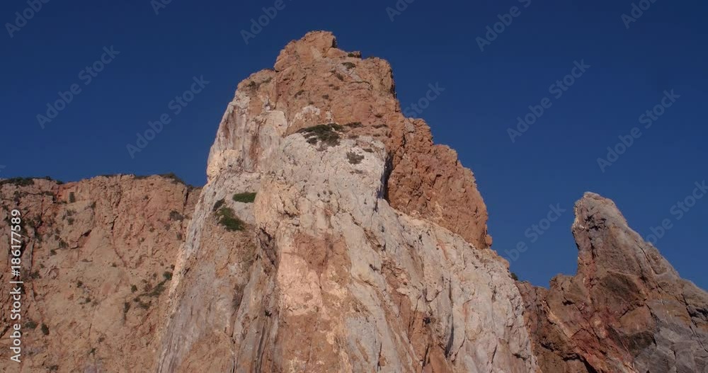 SARDINIA, ITALY – JULY 2016 : Video shot of cliffs on Porto Flava beach on a sunny day with blue sky in view SARDINIA, ITALY – JULY 2016 : Video shot of cliffs on Porto Flava beach on a sunny day with blue sky in view