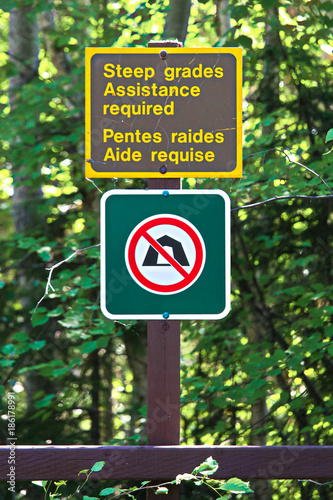 Steep grades assistance required and a no camping sign