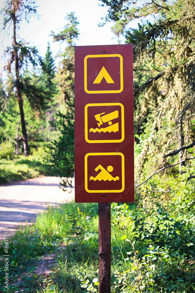 A camping, boat launch and swimming sign A camping, boat launch and swimming sign