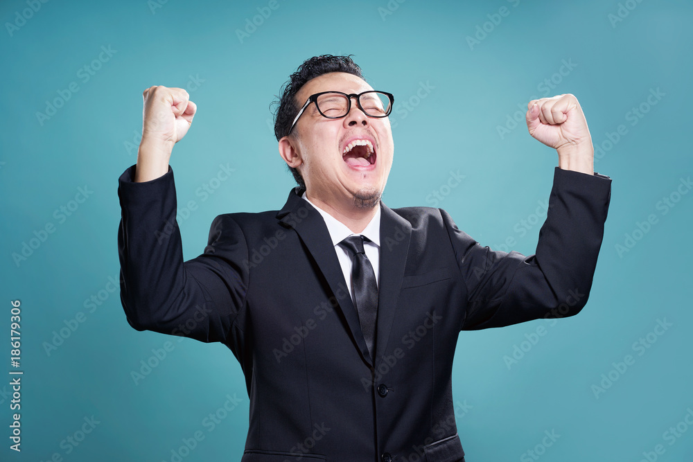 Excited businessman isolated on the cyan background . Excited businessman isolated on the cyan background .