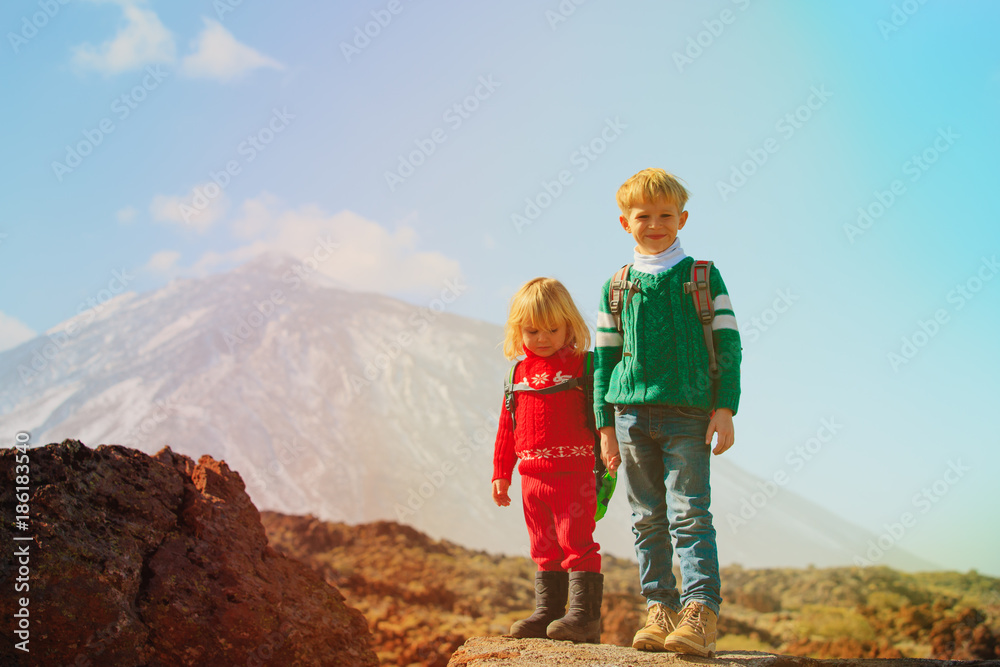 little boy and girl hiking in mountains
