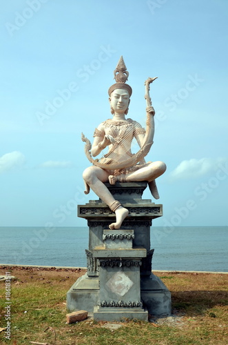 Embankment in Kep, Cambodia. Beautiful buddhist statue on the bank of the sea