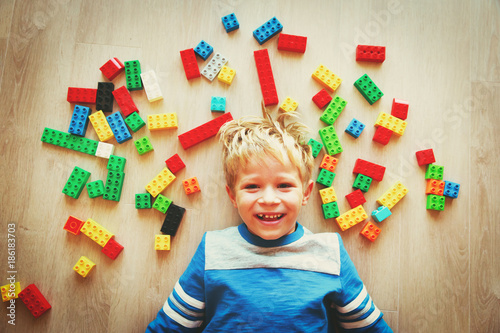 cute little boy love playing with plastic blocks
