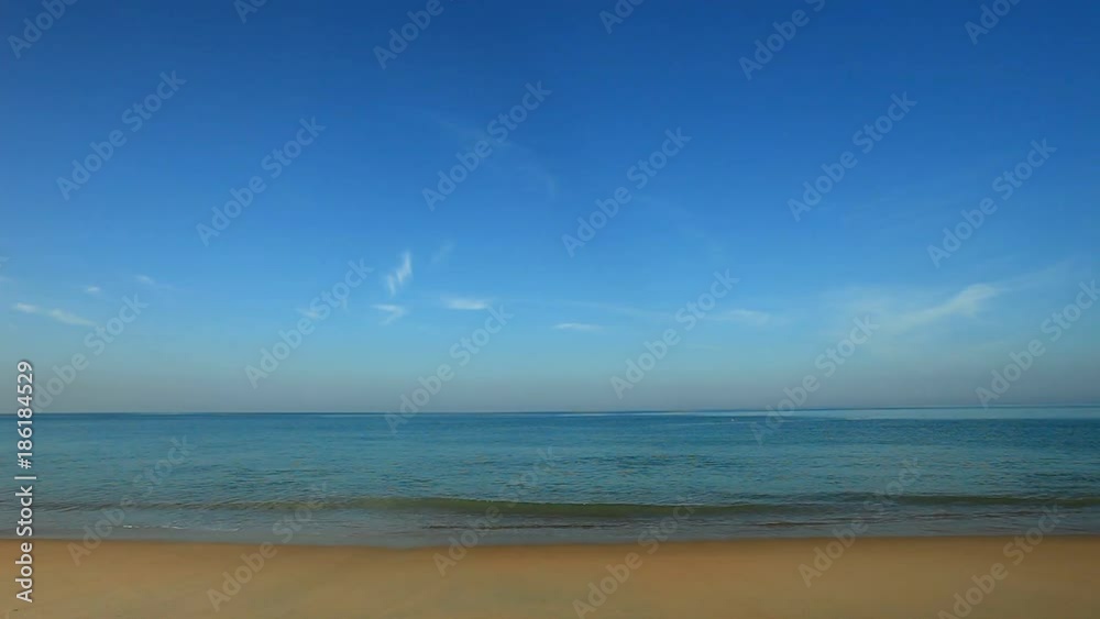 tropical andaman seascape scenic off mai khao beach phuket thailand with wave crashing on sandy shore
