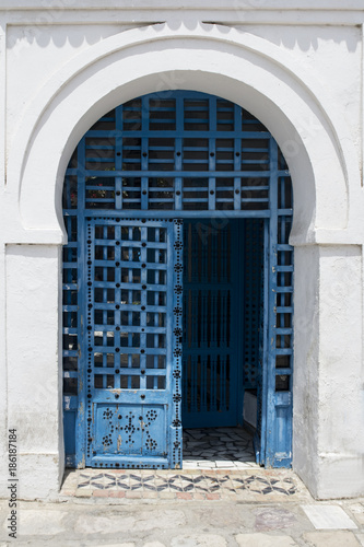 Blue wooden door with arch from Sidi Bou Said in Tunisia