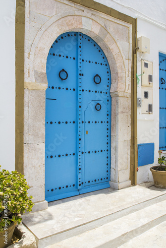 Blue wooden door with arch from Sidi Bou Said in Tunisia