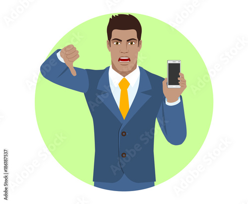 Businessman with mobile phone showing thumb down gesture as rejection symbol