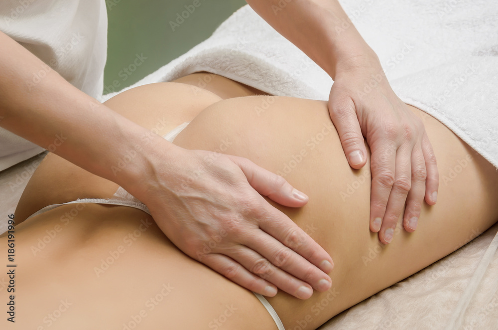 Anticilulite professional massage on the female buttocks in the salon. Anticilulite professional massage on the female buttocks in the salon.