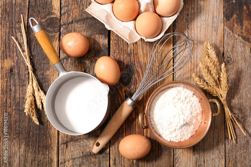 flour,egg,milk on wood background