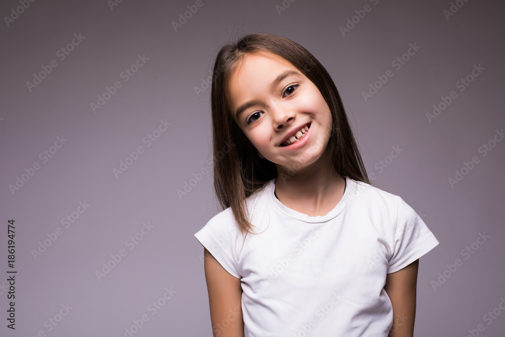 Portrait of Beauty happy little girl a on gray background