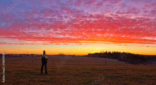 Young man stand and looking to famous witer sunrise on Czech countryside