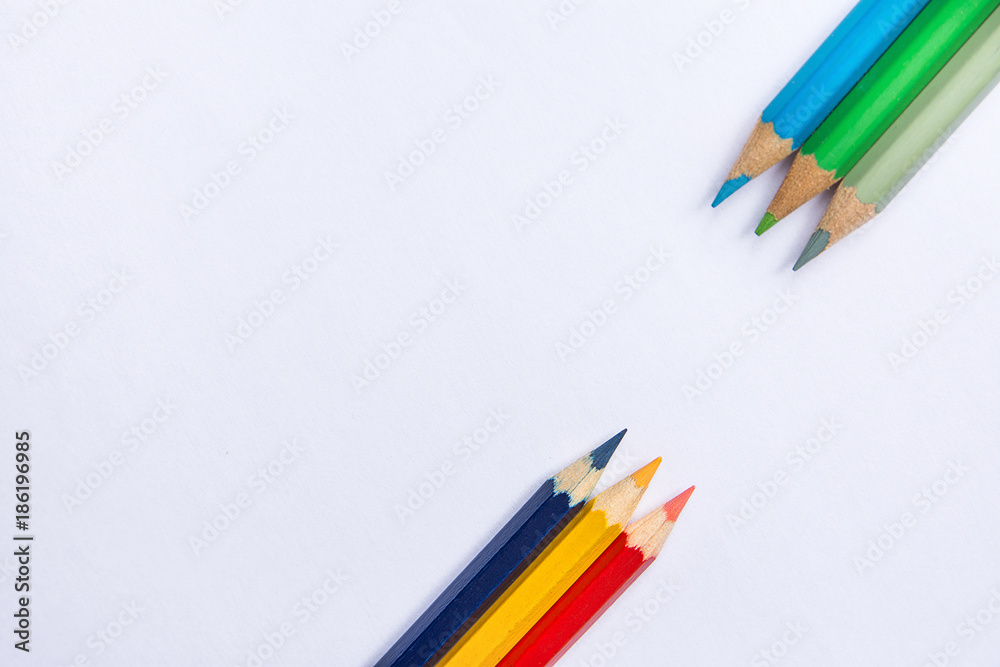 Fototapeta premium Rows of Multicolored Pencils in Diagonal Position Bottom and Top on White Paper Background. Business Creativity Graphic Design Crafts Kids School Concept. Copy Space