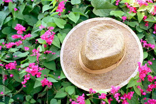 Handmade hat weave on leaf and pink flowers  background