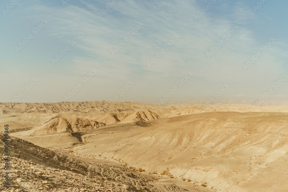 Landscape of mountain hill dry desert in Israel. Valley of sand, rocks and stones in hot middle east tourism place.