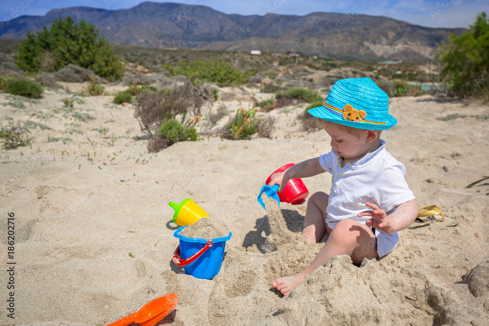 Little boy playing in the sand on holidays in Greece Little boy playing in the sand on holidays in Greece