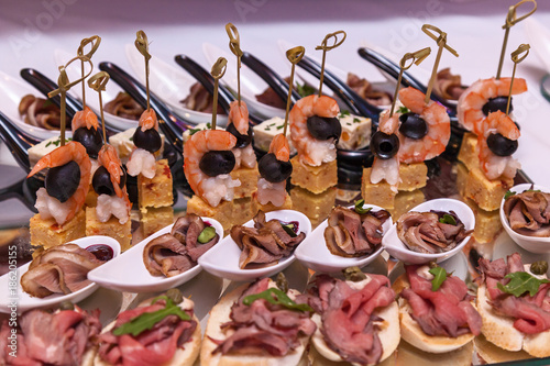 Shrimp with olives, cheese with grapes and canapes with meat. Cocktail Reception photo