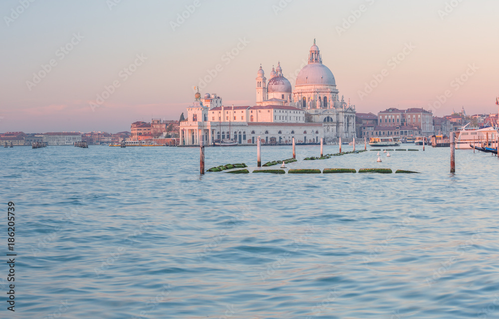 Grand Canal and Basilica Santa Maria della Salute in Venice at surise, rose-colored.