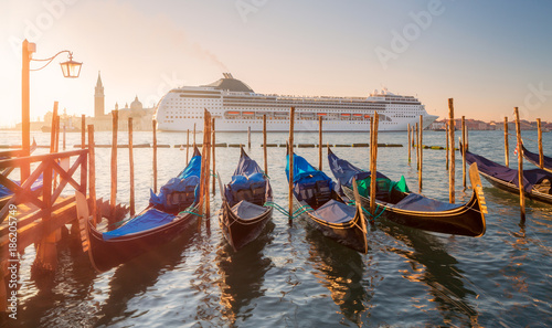 Beautiful view of Grand Canal, row of boats and modern motor ship at background,Italy © Valeriy