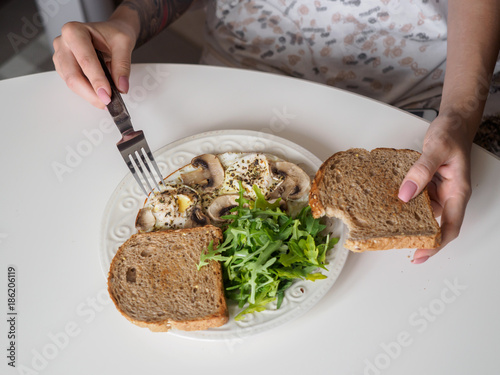 Omelette eggs with mushrooms and arugula. Breakfast with cheese and bread