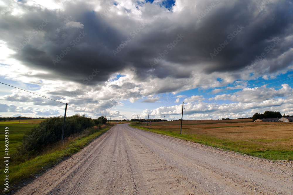 Gravel road in cloudy day.