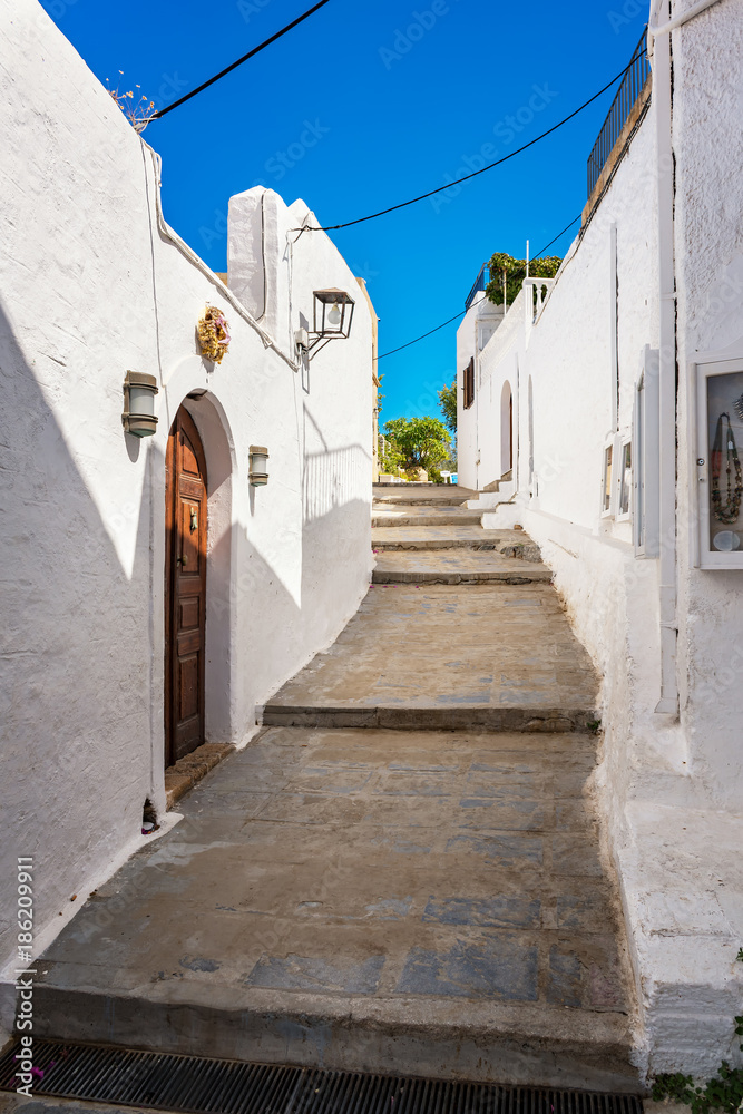 Streets of Lindos village with traditional houses and villas (Rhodes, Greece)
