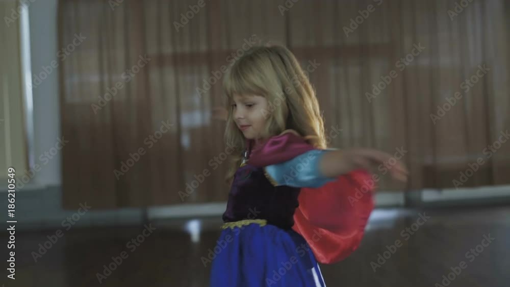 Portrait of little girl in costume of princess posing at camera Portrait of little girl in costume of princess posing at camera
