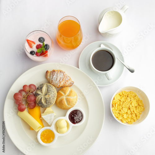 Rich continental breakfast. French crusty croissants, muesli, lots of sweet fruits and berries, hot coffee for morning meals.