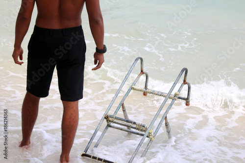 Lifeguards with ladders for long-tail boat on the beach