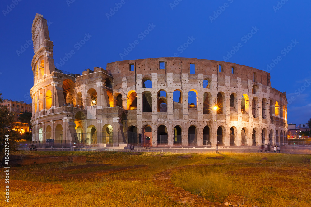 Colosseum or Coliseum during blue hour, also known as the Flavian Amphitheatre, the largest amphitheatre ever built, in the centre of the old city of Rome, Italy.