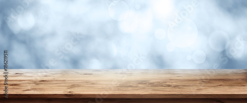 Blue winter background with wooden table photo