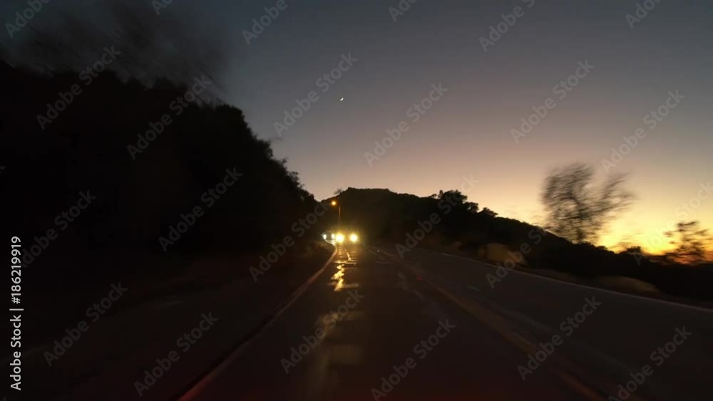Night rear view driving time lapse on Box Canyon road between Los Angeles and Simi Valley in Southern California. Night rear view driving time lapse on Box Canyon road between Los Angeles and Simi Valley in Southern California.