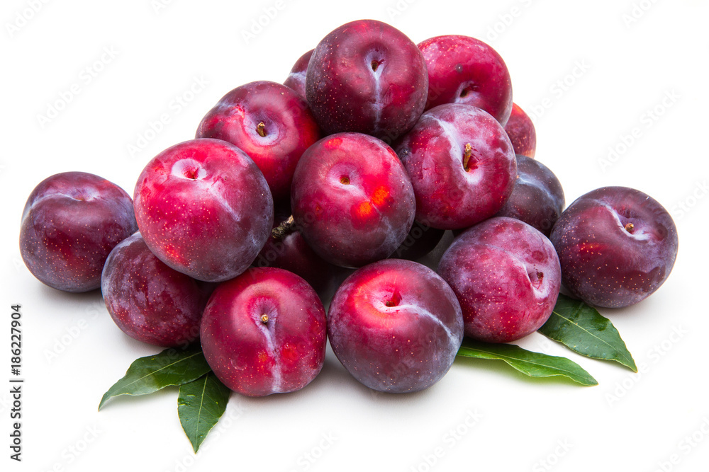 group of red plums on white background