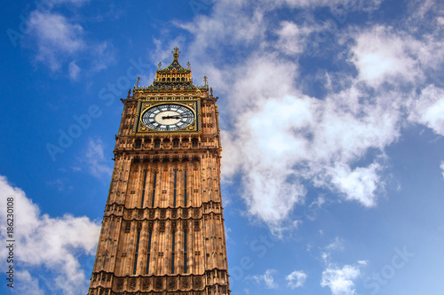 Big Ben on clear blue sky with a few clouds. London, United Kingdom.