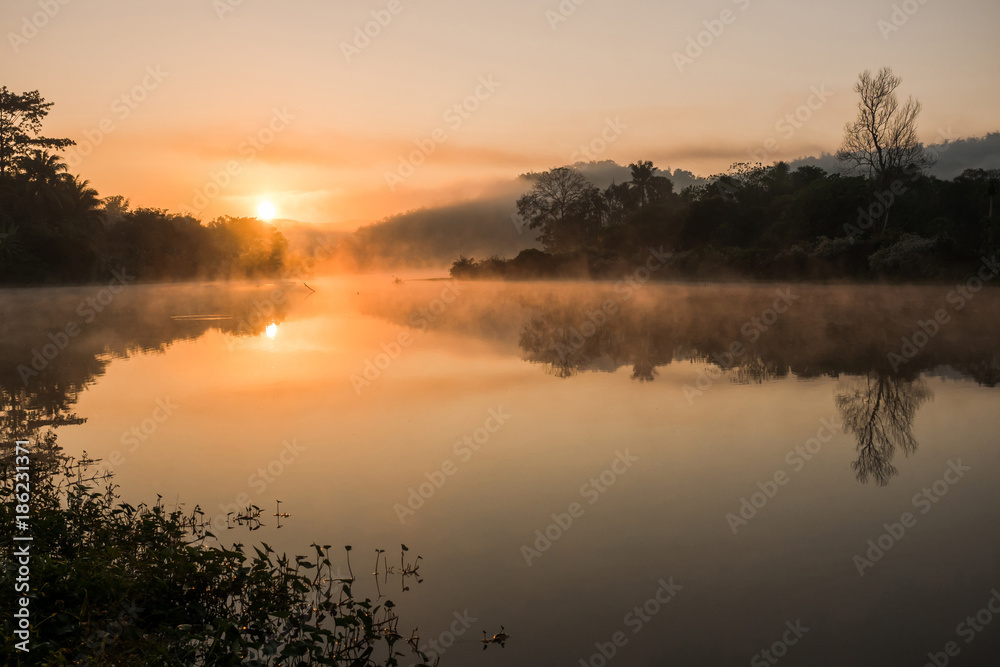 Sunrise on the river with misty