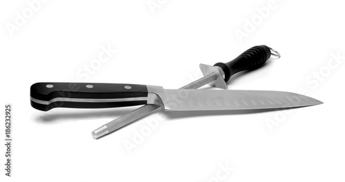 Black kitchen knife and sharpener on the white