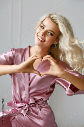 Love. Beautiful Female Model Showing Heart With Hands. photo