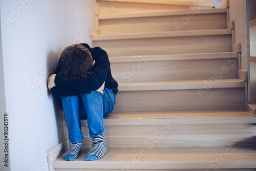 Sad crying child alone photo