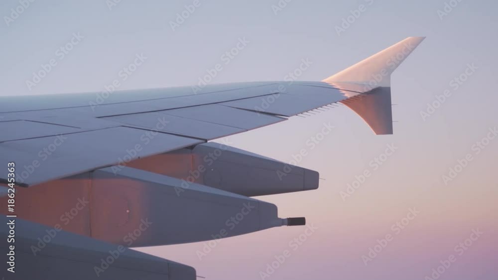 plane wing during flight in sunrise plane wing during flight in sunrise