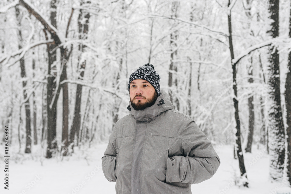 a man in a snowy forest a man in a snowy forest