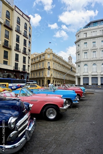 Classic American cars parked in Downtown Havana, Cuba. © Nayelie
