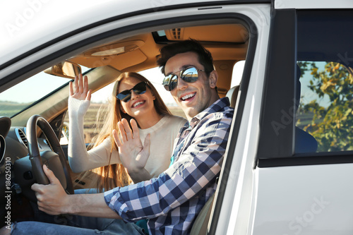 Beautiful young couple in car