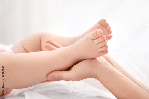 Mother holding her baby's feet, closeup