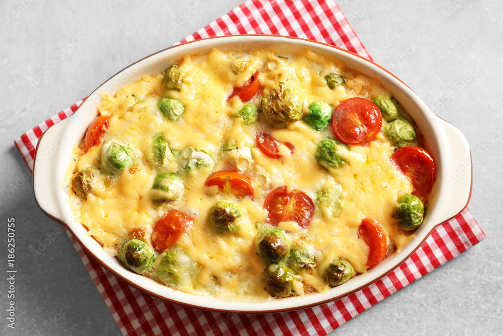 Baking dish with yummy brussel sprouts casserole on table Baking dish with yummy brussel sprouts casserole on table