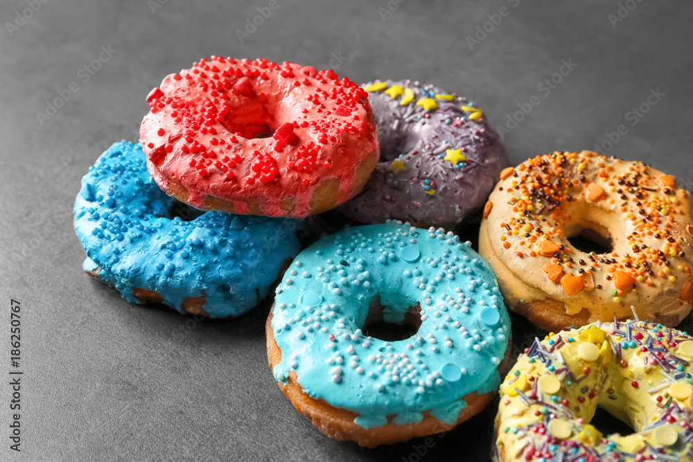 Fresh yummy colorful donuts on grey background Fresh yummy colorful donuts on grey background