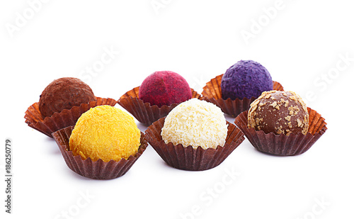 Assorted chocolate truffles on white background